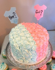 Photo of a pink and light blue cake for baby gender reveal party