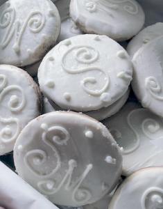 Photo of white sugar cookies with name initials for wedding anniversary