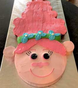Photo of a female troll shaped pink cake